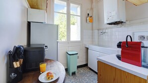 A kitchen with a refrigerator, sink, and a window. - Elegant Apartment 1br/4p - Paris 15/montparnasse (Paris)
