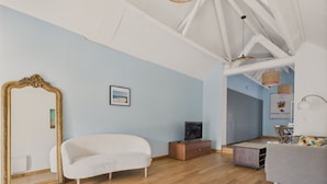 A spacious room with a large mirror, a sofa, a television, and a dining area. - House w/ garden & terrace – 6 adults/2 kids (La Baule-Escoublac)