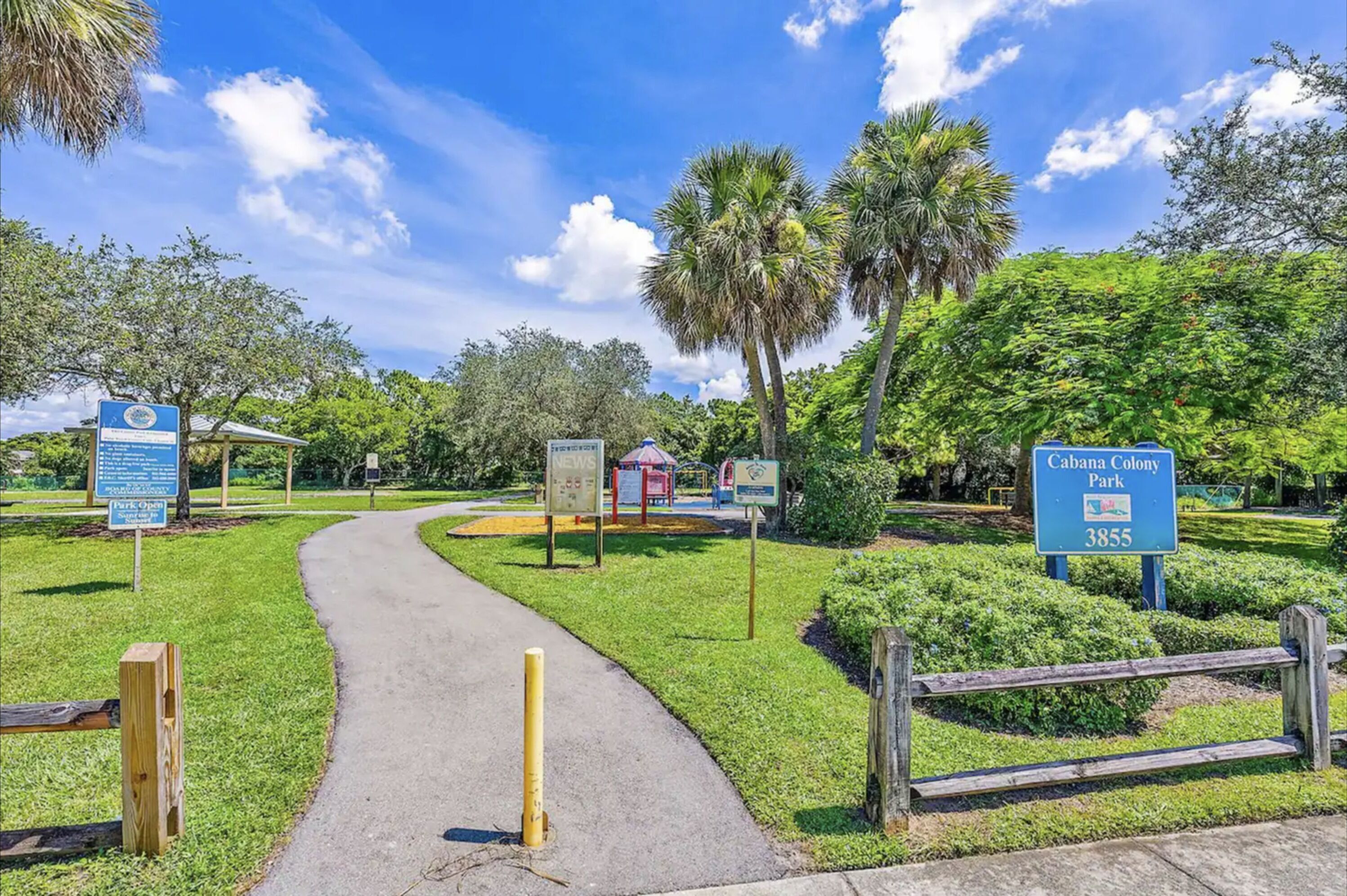 A pathway leading through a park with signs indicating 'Cabana Colony Park' and '3855'.