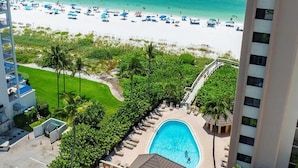A resort with a swimming pool, beach, and palm trees. - Beachfront 2BR condo in Marco Island with pool and WiFi. (Marco Island)