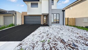 A modern two-story house with a garage, a driveway, and a gravel front yard. - `Brand New`, Spacious, Breezy Comfy, Luxury Home ! (Berwick)