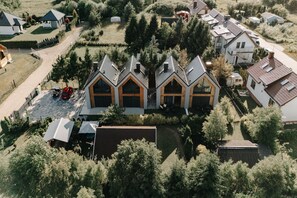 A residential area with multiple houses, including a prominent building with a gabled roof and large windows. - Holiday Home Near the Sea, air Conditioning (Ustronie Morskie)
