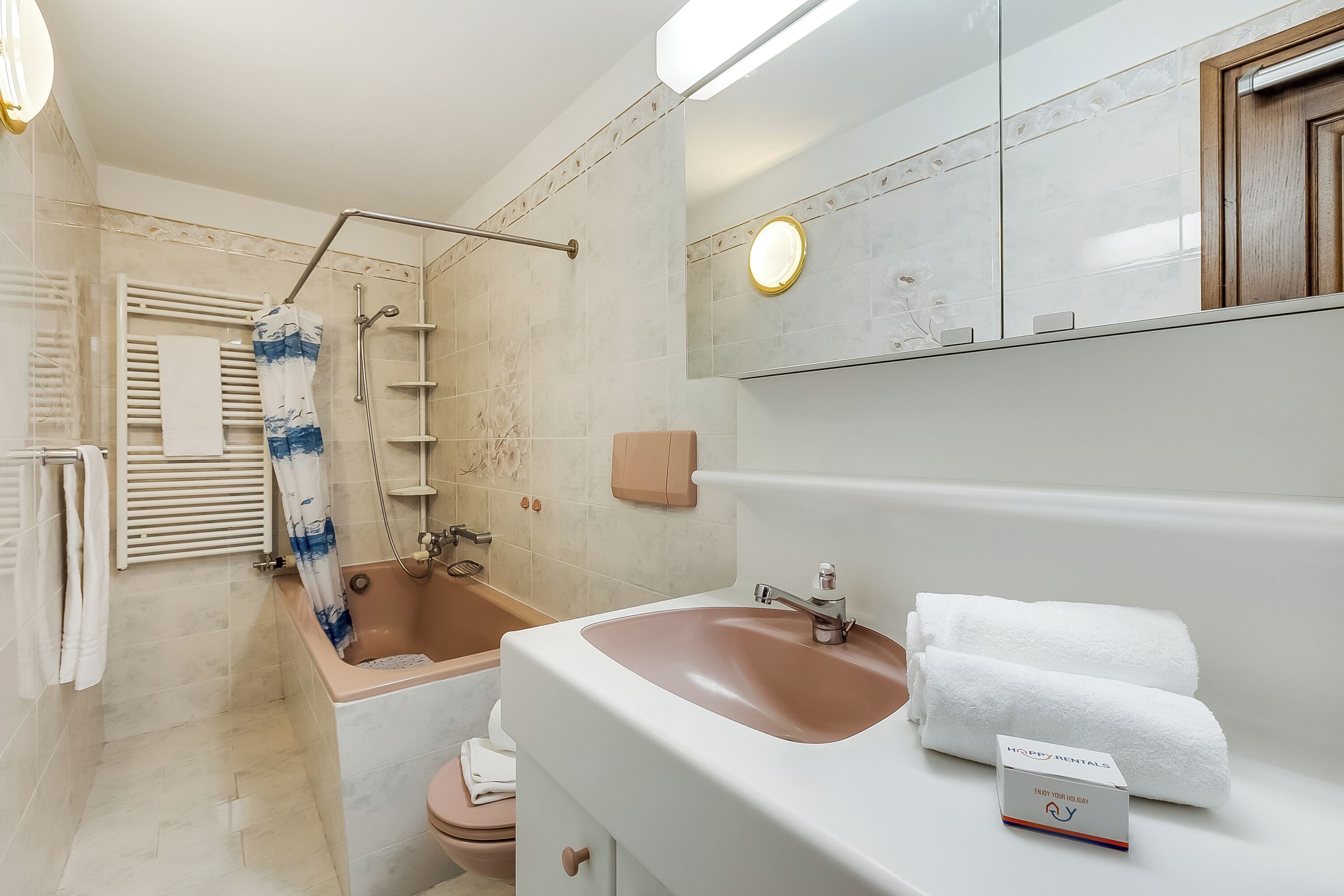 A bathroom with a bathtub, a toilet, a sink, and a shower.