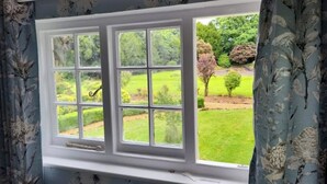 A window with a view of a well-maintained garden. - The Lodge and Gardener's Cottage at Historic Fairfield Court (Fairfield)