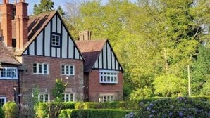 A large, traditional Tudor-style house with a well-maintained garden. - The Lodge and Gardener's Cottage at Historic Fairfield Court (Fairfield)