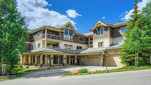 A two-story building with a covered entrance, large windows, and a stone facade. - 3BR Ski In Penthouse, Steps to Snowflake Lift! (Breckenridge)