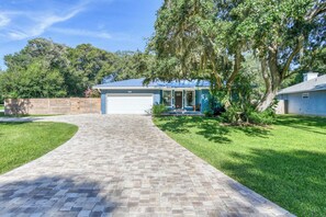 A residential house with a paved driveway leading to a garage. - San Rafael- Heated Pool & King Beds Near: Amphitheatre, Historic Downtown, Beach (St. Augustine)