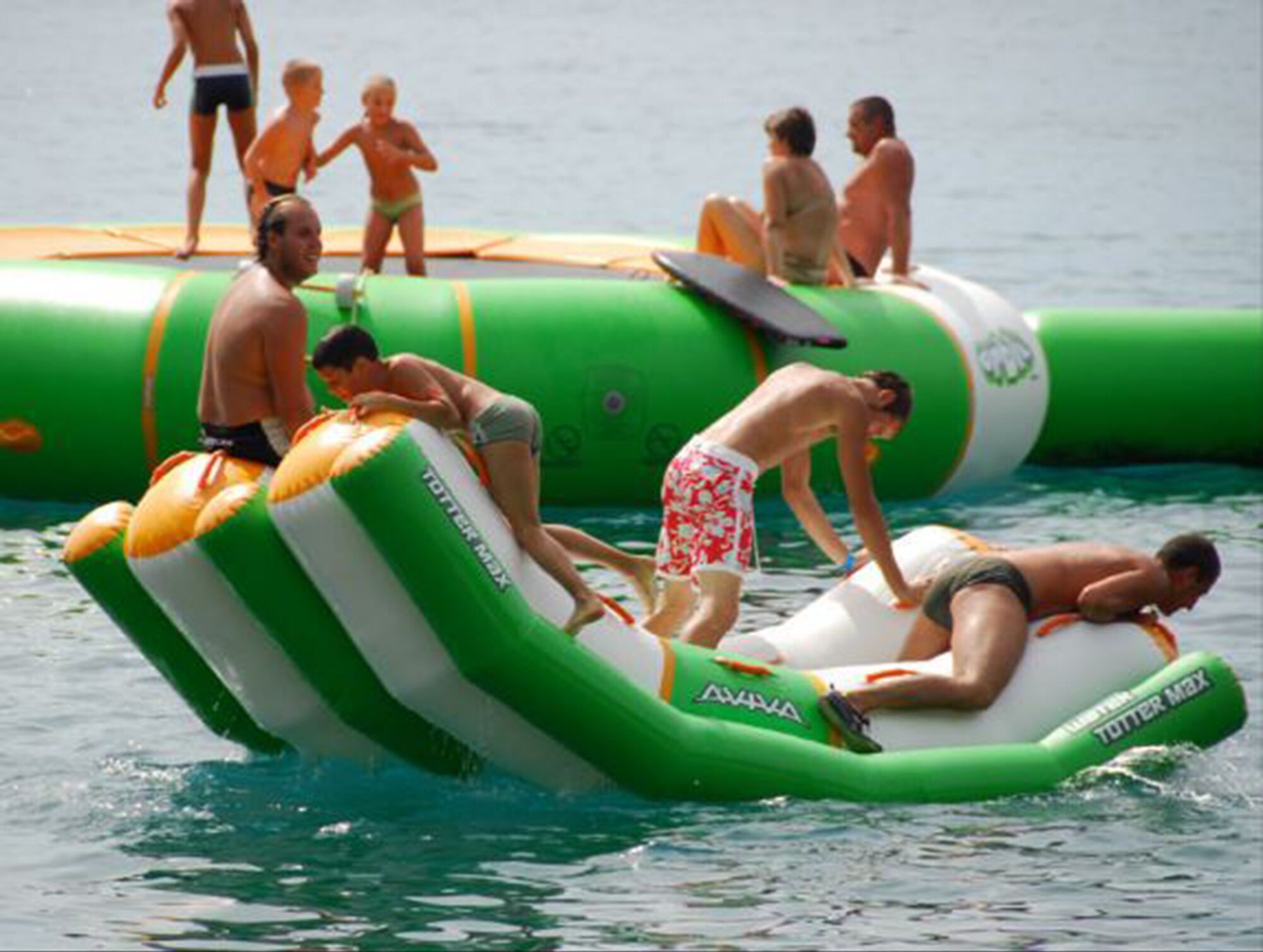 People on inflatable water floats in a body of water.