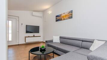 Standard Apartment, Balcony, Courtyard View | Living area | 100-cm Smart TV with satellite channels
