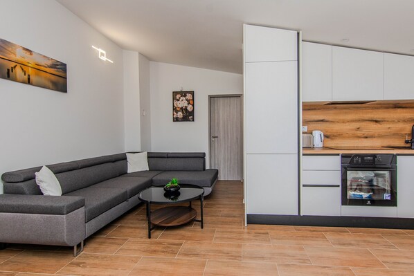 Standard Apartment, Balcony, Courtyard View | Living area | 100-cm Smart TV with satellite channels