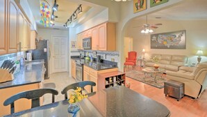 A spacious living area with a kitchen, dining table, and seating. - Tampa Home w/ Private Backyard ~ 15 Mi to Downtown (Tampa)