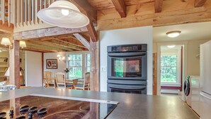 A kitchen with a large island, built-in oven, and a dining area with chairs. - Rural Retreat 3 Mi to Morrisville & Rail Trail! (Hyde Park)