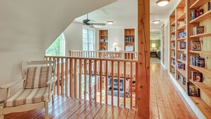 A wooden deck with a chair, a bookshelf, and a ceiling fan. - Rural Retreat 3 Mi to Morrisville & Rail Trail! (Hyde Park)