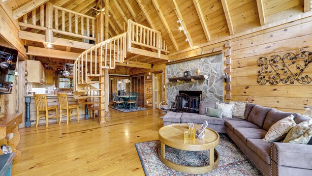 A spacious wooden interior with a staircase, a fireplace, and a cozy seating area. - Panoramic Mountain Views & Decks: Franklin Cabin! (Franklin)