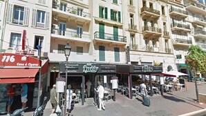 A street view with a cafe named 'Cave à Cigarettes' and a 'Gretty' shop.