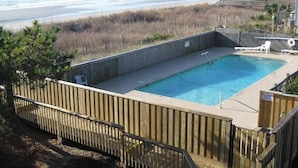 A swimming pool with a view of the beach and ocean.