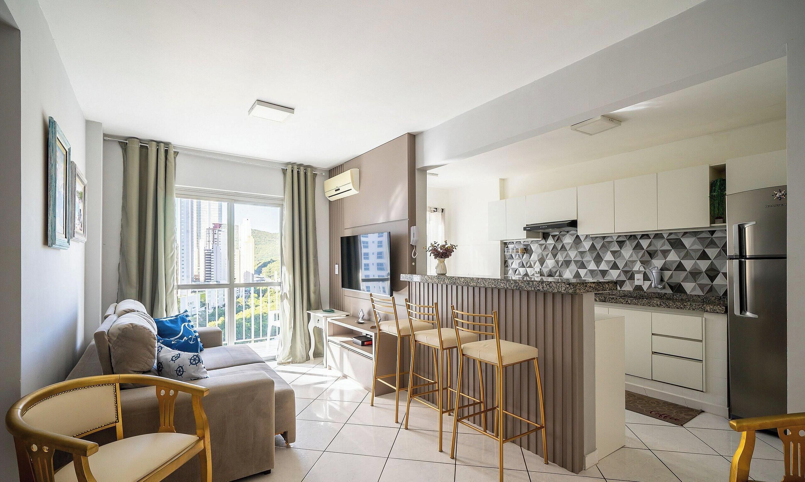 A modern apartment with a living room, kitchen, and dining area.