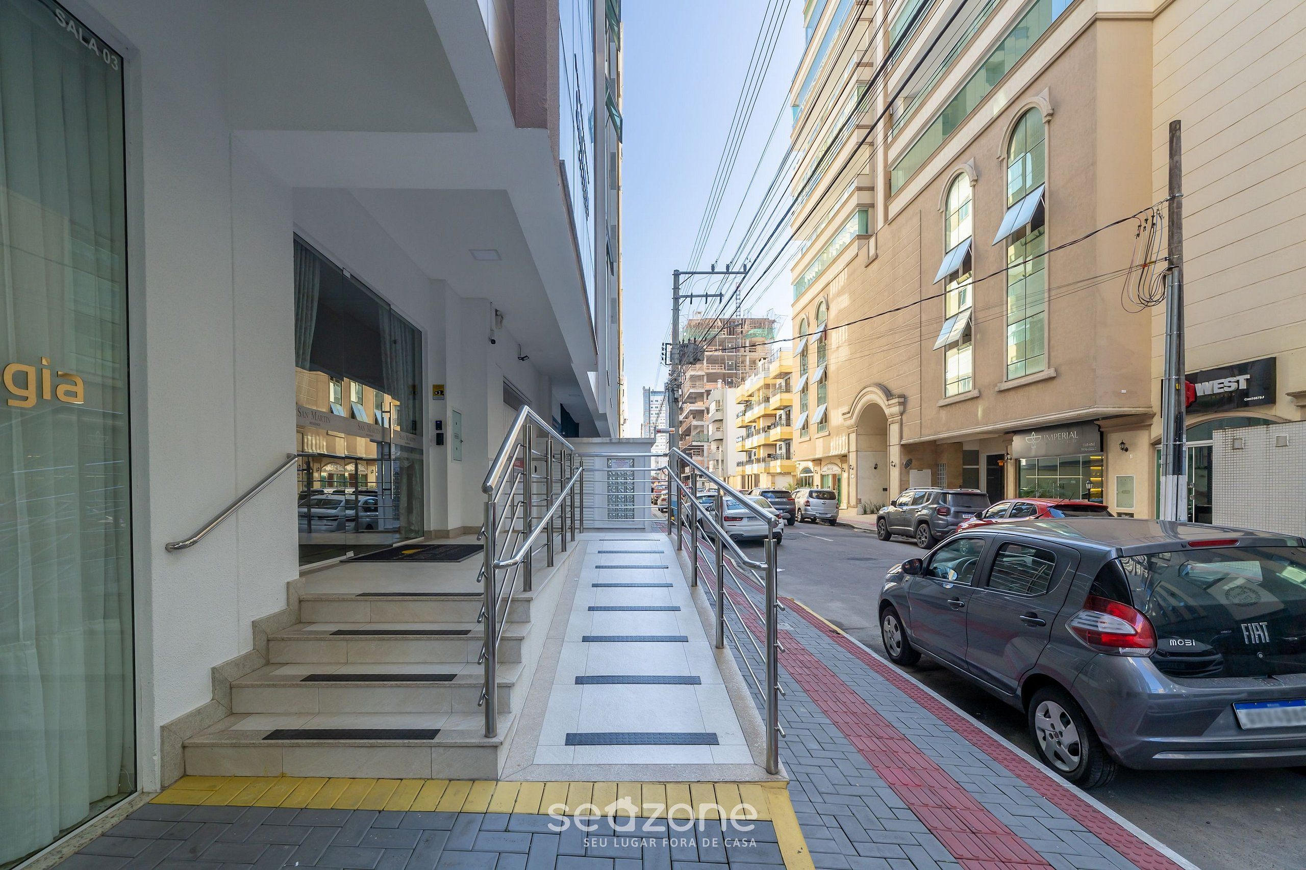 A multi-story building with a staircase leading to an entrance.