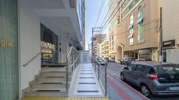 A multi-story building with a staircase leading to an entrance.