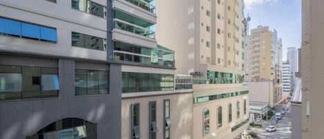A multi-story building with a modern architectural design, featuring large windows and balconies.