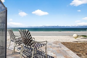 Outdoor seating with a view of the beach and ocean.