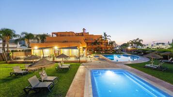 Seasonal outdoor pool, open 9:00 AM to 8:00 PM, pool umbrellas