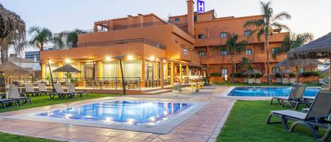 Seasonal outdoor pool, open 9:00 AM to 8:00 PM, pool umbrellas