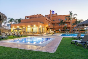 Seasonal outdoor pool, open 9:00 AM to 8:00 PM, pool umbrellas