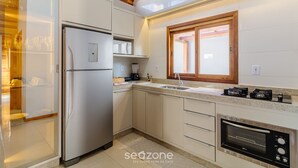 A modern kitchen with a built-in refrigerator, oven, and microwave.