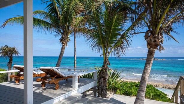 A wooden deck with lounge chairs and a view of the ocean. - Veselka - Remodeled Home On Double Bay Beach 3 Bedroom Home (Double Bay)
