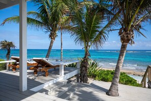 A wooden deck with lounge chairs and a view of the ocean. - Veselka - Remodeled Home On Double Bay Beach 3 Bedroom Home (Double Bay)