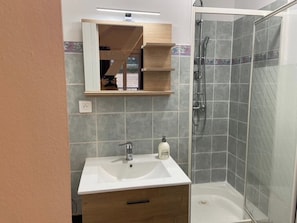 Shower, hair dryer, towels, toilet paper