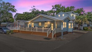 A single-story house with a porch, a small deck, and a flagpole. - Ocean Lakes Z49 | Lakeview 3BR Ground-Level Retreat Comp Golf Cart (Myrtle Beach)