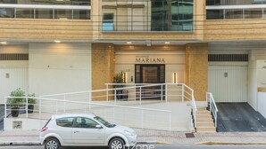 A building with a sign reading "RESIDENCIAL MARIANA" and a white car parked in front. - 3 Bedroom Apartment 130m From the Beach Mmp0137 (Itapema)