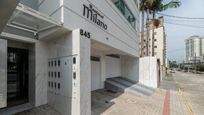 A modern building with a sign reading "Milano 845 Residential." - 2BR Apt With BBQ in Meia Praia Mlo0601 (Itapema)