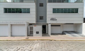 A modern building with a sign reading "Residential Milano" and a set of double doors. - 2BR Apt With BBQ in Meia Praia Mlo0601 (Itapema)
