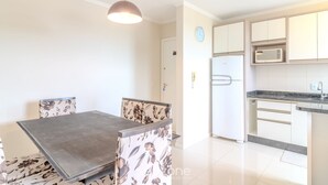 A modern kitchen with white cabinets, a built-in microwave, and a stainless steel refrigerator. - Building With a Pool 400m From Beach - LEA (Picarras)