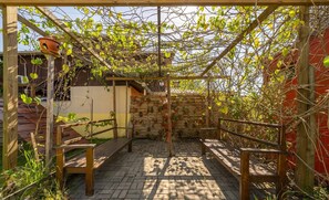 A wooden pergola with climbing plants, a brick patio, and wooden benches. - 5BR House w/ Pool Near Beto Carrero SC Jrs0045 (Penha)