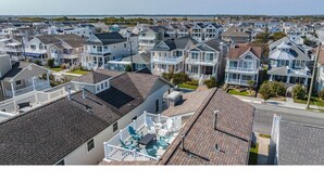 A residential area with multiple houses, some with visible porches and a swimming pool area. - Gold Coast 3BR Condo / Decks, Parking, Walk to Beach (Ocean City)