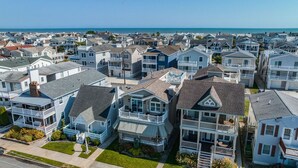 A coastal residential area with multiple two-story houses featuring balconies and waterfront views. - Gold Coast 3BR Condo / Decks, Parking, Walk to Beach (Ocean City)