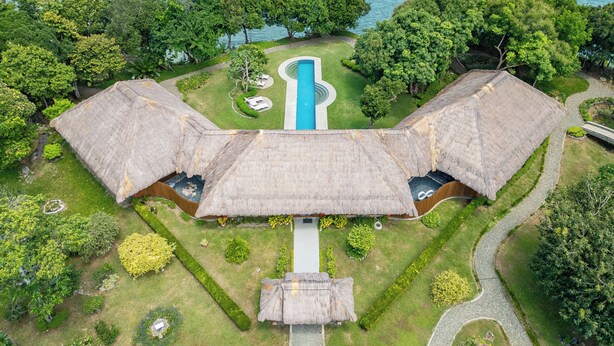 A resort with thatched-roof villas, a central swimming pool, and lush greenery. - CLIFF HOUSE at LILI CLIFF (Ferrol)
