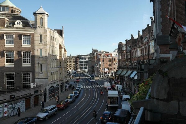 A street view with historic buildings, a tram, and a clear sky. - Hotel Galerij Amsterdam  (Amsterdam)