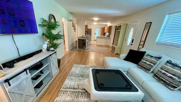 Un salon moderne avec un canapé, une table basse et un meuble pour appareils multimédias.