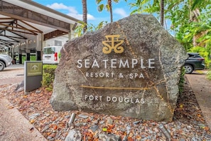 A large stone sign with the name 'SEATEMPLE RESORT & SPA' and 'PORT DOUGLAS' written on it. - Relaxed Swim-out Nook by Four Mile Beach (Port Douglas)