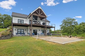 A two-story house with a covered patio, outdoor seating, and a concrete volleyball court. - Grand Ole View on Center Hill Lake in Smithville, TN (Smithville)