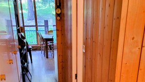 A wooden hallway with a rug featuring a cartoon character, leading to a dining area with tables and chairs. - 50m from resort center, 3rd floor, balcony, tv, 48m², Les Arcs (Les Arcs)