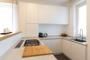 Comfort Apartment | Private kitchen | Full-size fridge, oven, stovetop, dishwasher