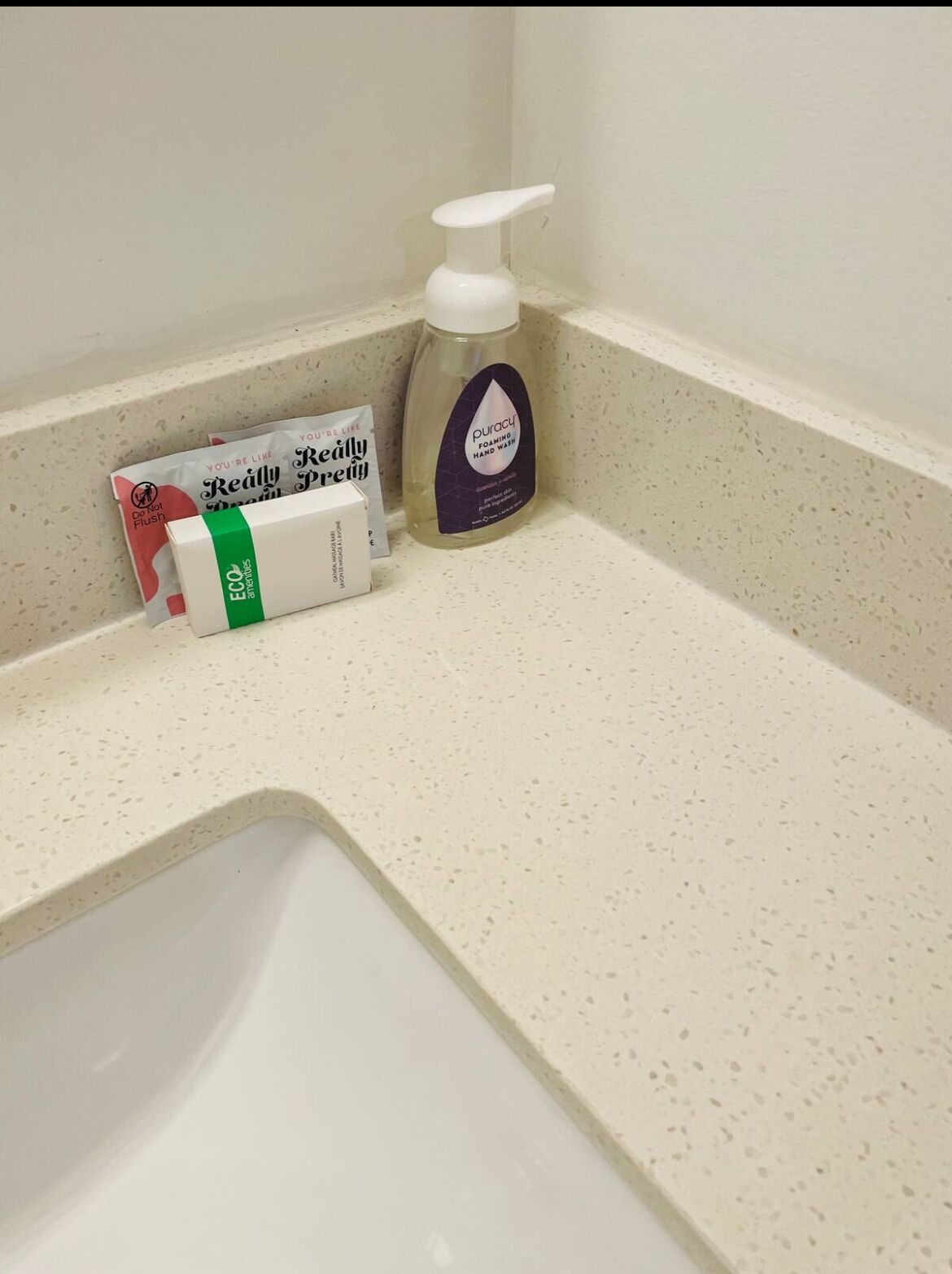 A bathroom sink with a soap dispenser and a bar of soap.