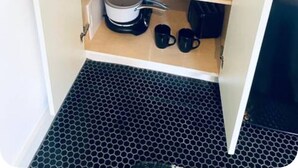 A compact kitchen with a wooden countertop, a potted plant, a coffee maker, and a set of kitchen utensils. - Texas Bluebonnet Décor Walkable Montrose Studio 14 Centralize Suite Studio! (Houston)