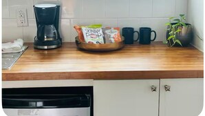 A kitchen with a coffee maker, a bowl of snacks, and a potted plant. - Texas Bluebonnet Décor Walkable Montrose Studio 14 Centralize Suite Studio! (Houston)